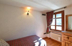 a bedroom with a bed and a window at Amazing Apartment In Cogne in Cogne