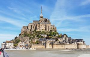 a castle on top of a mountain with a beach at Agréable Jardin Et Terrasse in Sourdeval +11 photos