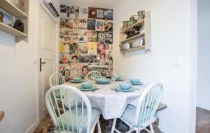 a dining room with a table and chairs at Agréable Jardin Et Terrasse in Sourdeval