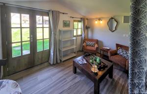 a living room with a couch and a table at Gite En Campagne in Avezé