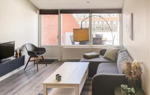 a living room with a couch and a tv at Awesome Apartment In Faaborg With Sauna in Faaborg