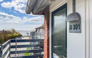 a door on a building with a view of the water at Awesome Apartment In Faaborg With Sauna in Faaborg +17 photos