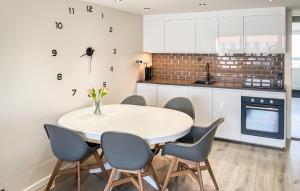a kitchen with a white table and chairs at Awesome Apartment In Faaborg With Sauna in Faaborg