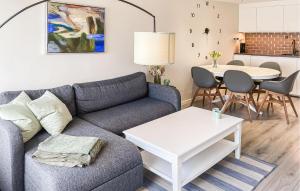 a living room with a couch and a table at Awesome Apartment In Faaborg With Sauna in Faaborg