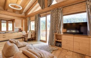 a living room with a large flat screen tv at Gorgeous Home In Sappada With Sauna in Sappada