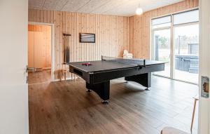 a ping pong table in a room with wooden walls at Gorgeous Home In Grenaa With Sauna in Grenå