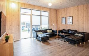 a living room with couches and a table at Gorgeous Home In Grenaa With Sauna in Grenå