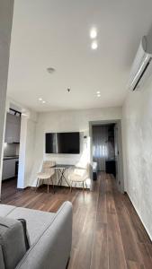 a living room with a couch and a table at Elios Near Centre Apartment in Tirana