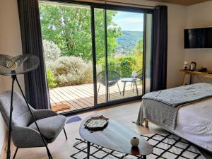 a bedroom with a bed and a sliding glass door at La Possibilité d'une Ile in Apt +56 photos