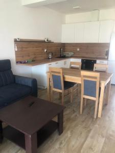 a living room with a table and a couch at Przystań dla rodziny in Tarnów +2 photos