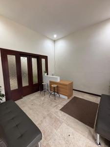 a living room with a couch and a table at Base Seven Hostel in Bandung
