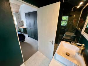 a bathroom with a sink and a mirror at Serenity Suite in Somerset West +15 photos