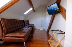 a living room with a couch and a painting on the wall at Republica Vintage House in Viana do Castelo