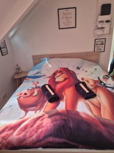 a bed with a painting of the little mermaid on it at Hakuna Matata in Saint-Brieuc +5 photos