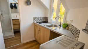 a small kitchen with a sink and a window at Hakuna Matata in Saint-Brieuc