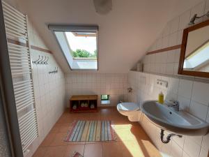 a bathroom with a sink and a toilet and a window at Naturerlebnishof Uferloos in Kienitz +79 photos