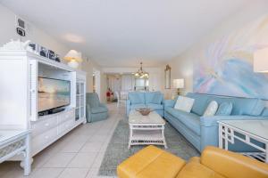 a living room with a blue couch and a tv at Driftwood Towers 6D condo in Gulf Shores