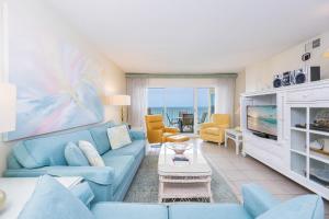 a living room with a blue couch and a table at Driftwood Towers 6D condo in Gulf Shores