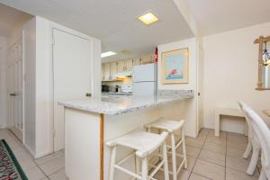 a kitchen with a counter and stools in a room at Driftwood Towers 6D condo in Gulf Shores
