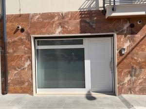 a garage door in front of a brick wall at Dimora Deluxe in San Severo