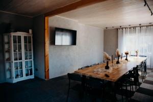 a dining room with a long table and chairs at Avotu rezidence Apē in Ape