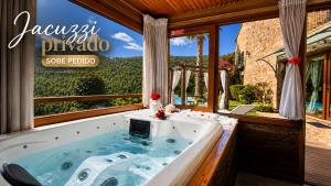 a bath tub in a room with a window at Casa Love Story - Piscina, Sauna & Jacuzzi in Arcos de Valdevez