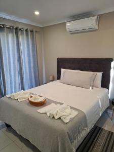 a bedroom with a bed with a basket on it at House Sawubona in Kroonstad