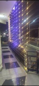 a building with lights on the side of it at HOTEL SEA ROCk in Belagula +1 photo