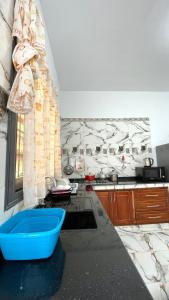 a kitchen with a blue bowl on a counter at Ain El Turk Beach Apartment in Aïn El Turk +1 photo