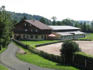 a large barn with a road in front of it at Boháček in Mladé Buky