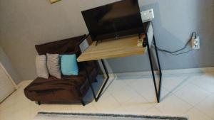 a living room with a couch and a television at Earth n' Water in Verga Kalamata