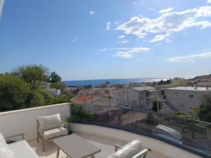 a balcony with a table and a view of the ocean at Apartment Bogunovic in Bar
