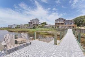 two chairs sitting on a dock next to the water at 7815 - Tarhoo in Frisco