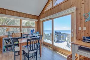 a dining room with a view of the ocean at 7815 - Tarhoo in Frisco +30 photos