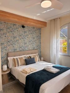 a bedroom with a large bed and a window at Gorgeous Golf Villa Heated Pool Sea view in Adeje +73 photos