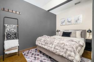 a bedroom with a large bed and a mirror at Jungle Book Luxe Suite Downtown BMO in Calgary