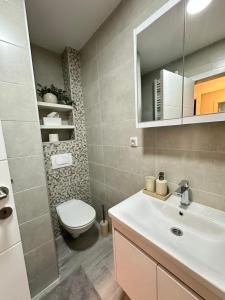a bathroom with a white sink and a toilet at Veles in Banja Koviljača +11 photos