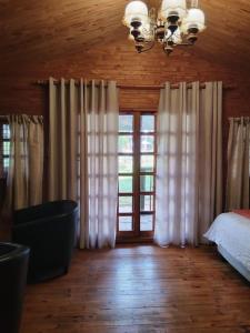a bedroom with a bed and a large window at Greenstone Guesthouse in Muldersdrift +74 photos
