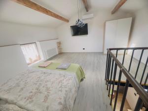 a bedroom with a bed in a room with stairs at La Casa Rossa II in Verona