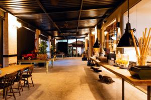 a large room with tables and cats sitting on the floor at Hotel Monreale Resort in Poços de Caldas