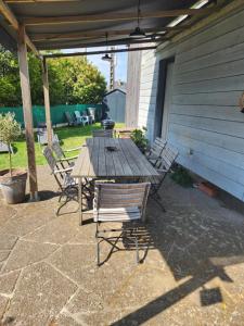 a wooden table and chairs on a patio at Charmante maison in Dinard