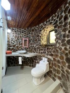 a stone bathroom with a toilet and a sink at Hotel El Jardin in Montezuma +78 photos
