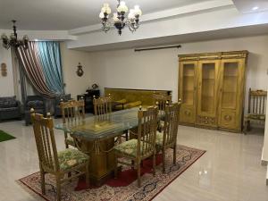 a dining room with a glass table and chairs at North Coast sedra resort Villa, قرية سيدرا الساحل الشمالي in Alexandria