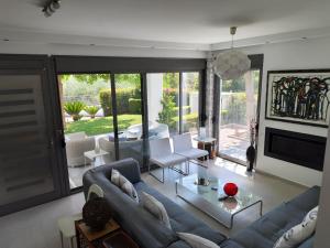 a living room with a couch and a table at Sea & Summit Pool Villa in Platamonas