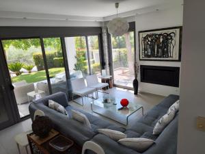 a living room with a couch and a table at Sea & Summit Pool Villa in Platamonas