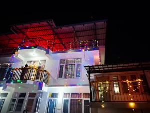 a building with christmas lights on it at night at Indu Homestay in Shimla