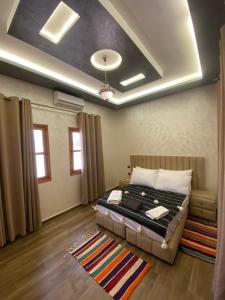 a bedroom with a bed and a couch in a room at Villa Laarich in Essaouira