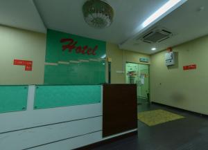 a hotel lobby with a hotel sign on the wall at SMC Hotel Seksyen 13 in Shah Alam