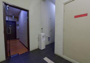 a hallway with a door leading to an elevator at SMC Hotel Seksyen 13 in Shah Alam +16 photos