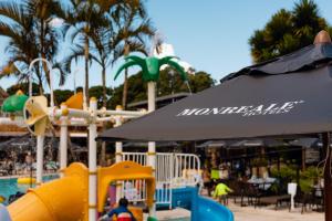 a water park with a water slide and an umbrella at Hotel Monreale Resort in Poços de Caldas